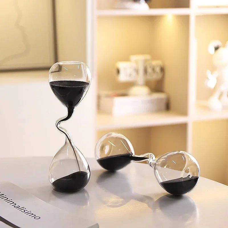 Hourglass curve design, black modern style, glass craftsmanship, simple indoor dining table decoration, beautiful sand clock