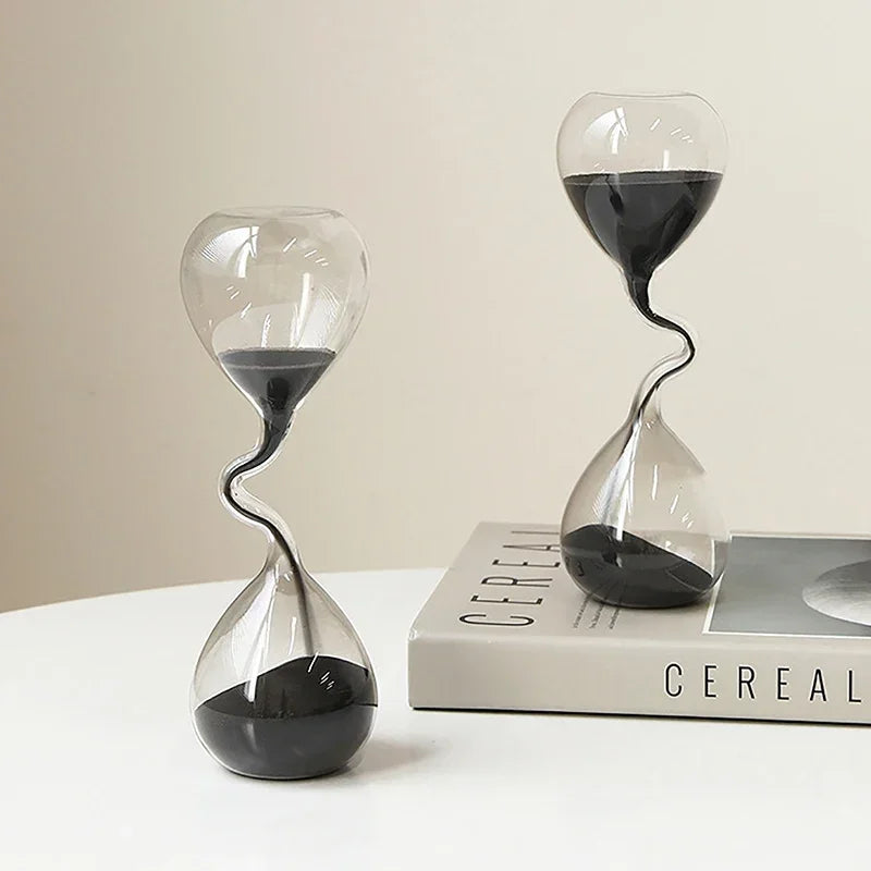 Hourglass curve design, black modern style, glass craftsmanship, simple indoor dining table decoration, beautiful sand clock